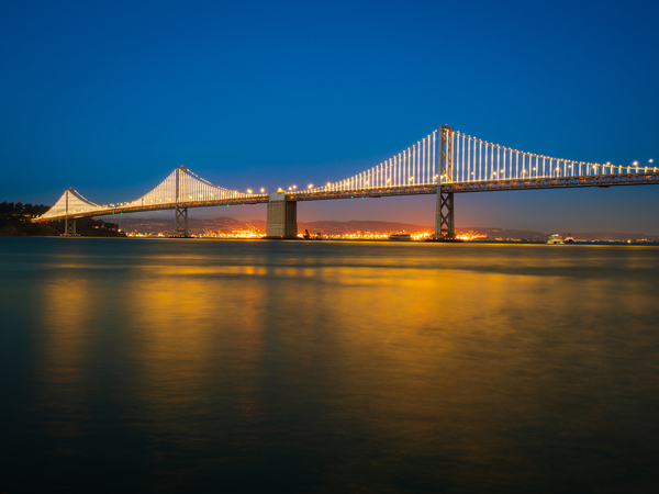 San Francisco Bay bridge illuminated at night by Steve Heap