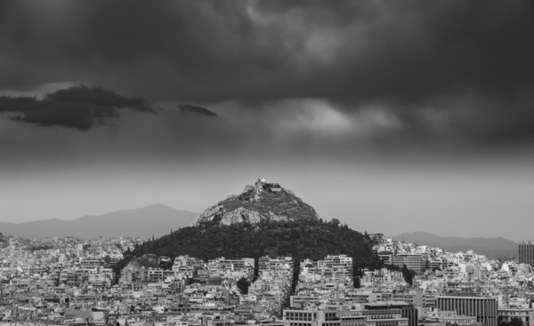 Lycabettus hill rises above Athens in a storm by Steve Heap
