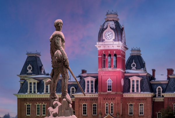 Mountaineer statue against Woodburn Hall tower by Steve Heap