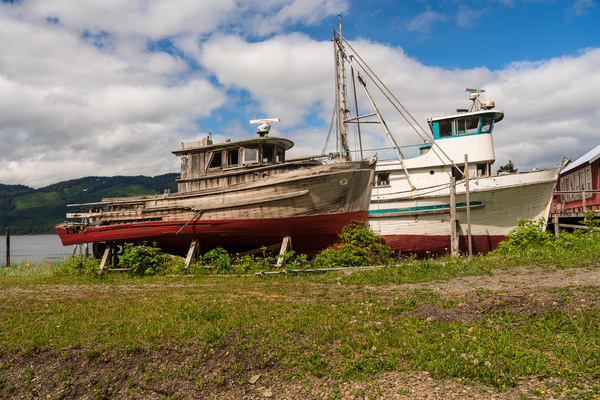 Historic but rotting fishing boats by ocean at Icy Strait Point by Steve Heap