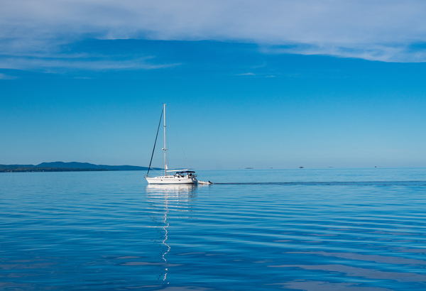 Yacht sailing peacefully across Lake Champlain by Steve Heap