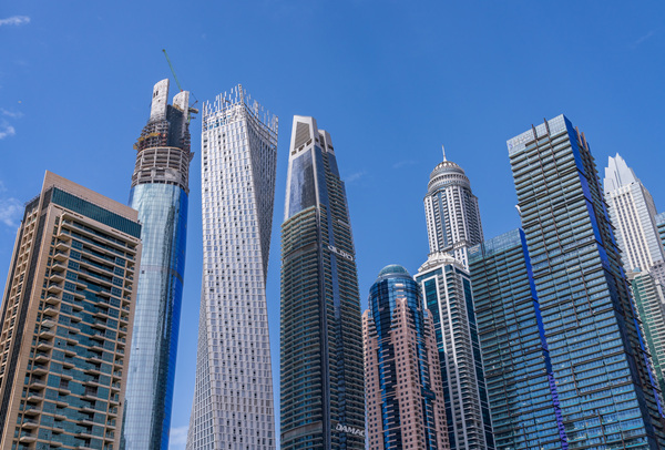 Cayan Tower among tall buildings on waterfront at Dubai Marina by Steve Heap