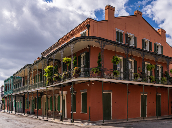 Traditional wrought iron balcony on ochre New Orleans house by Steve Heap