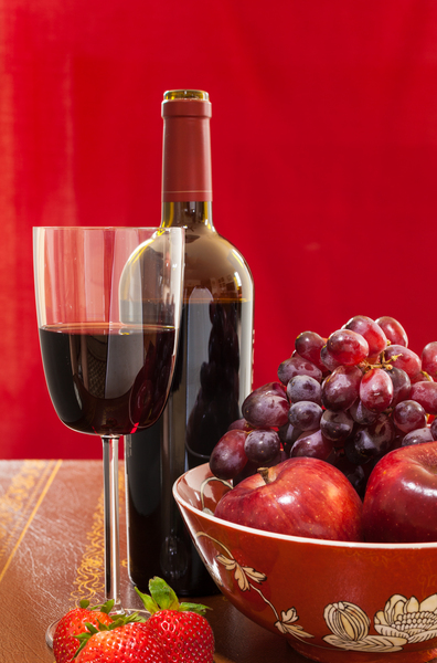 Red wine bottle and fruit with glass by Steve Heap