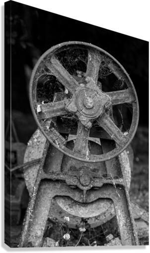 Rusty farm machinery with flywheel  Canvas Print