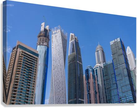 Cayan Tower among tall buildings on waterfront at Dubai Marina  Canvas Print