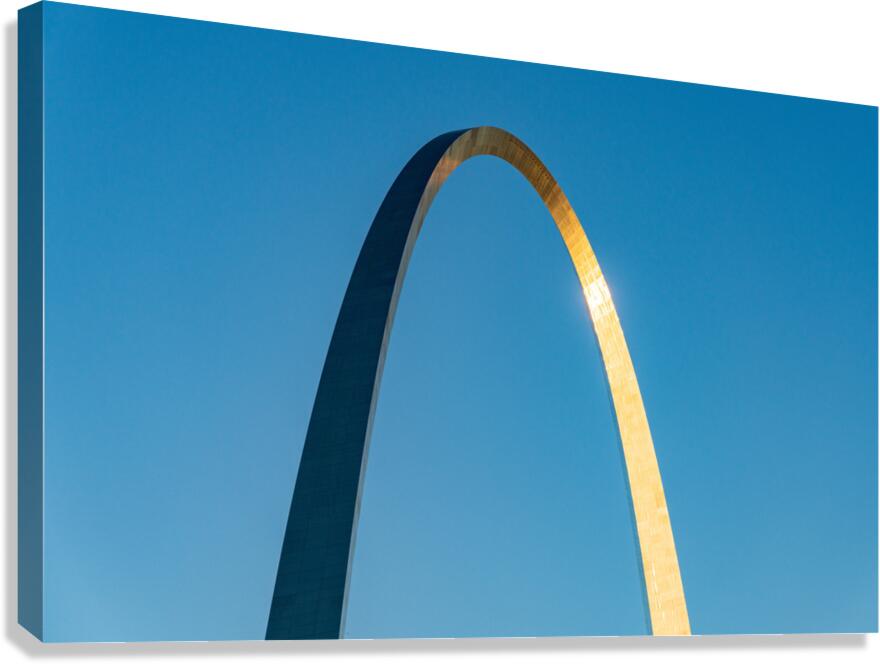 Unusual view of Gateway Arch at sunrise against blue sky  Canvas Print