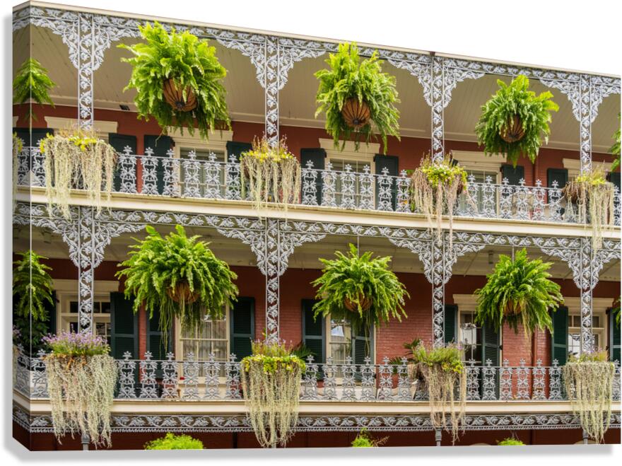Traditional wrought iron balcony on brick New Orleans house  Canvas Print