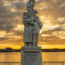 Monument to the Immigrant sculpture in New Orleans at sunrise