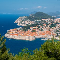 Fortress town of Dubrovnik in Croatia framed by trees