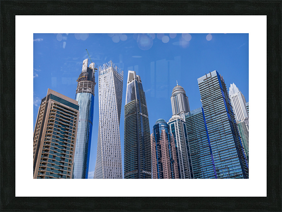 Cayan Tower among tall buildings on waterfront at Dubai Marina  Framed Print Print