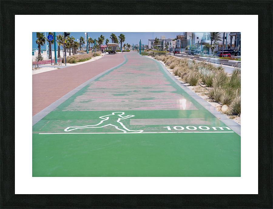 Rubber surface of running track alongside Dubai beach  Framed Print Print