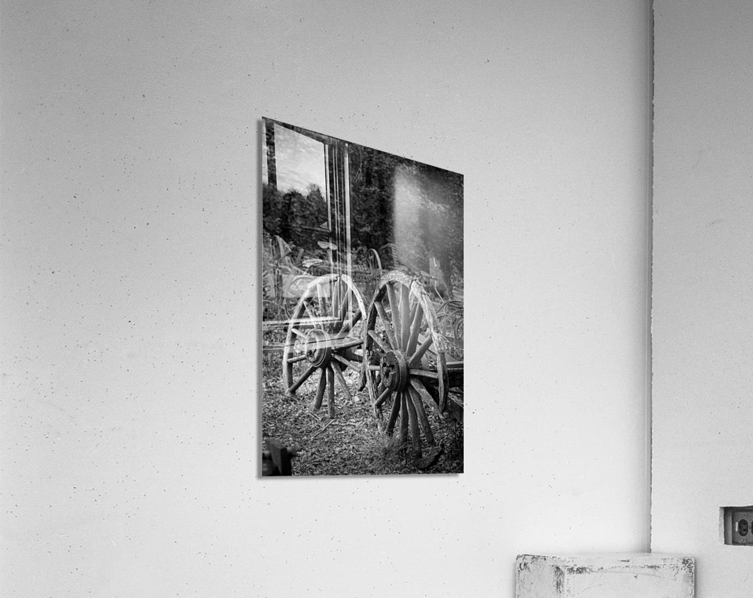 Two old wooden cartwheels against wood cart Acrylic Print
