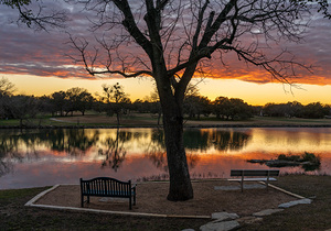 Dramatic sunset over Legacy Hills Park lake and golf course near