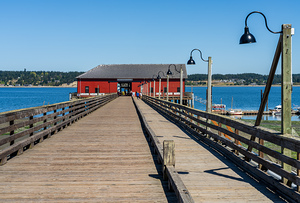 Wooden pier leading to famous red Coupeville wharf on Whidbey Is