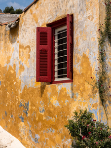 Red shutters on window in Anafiotika in Athens