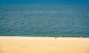 Single couple on wide beach at Cape May Point