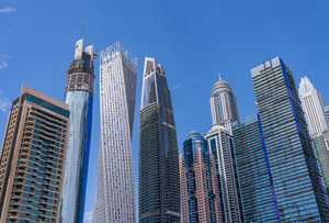 Cayan Tower among tall buildings on waterfront at Dubai Marina