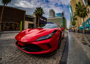 Red Ferrari parked in JBR Beach area of Dubai for rental