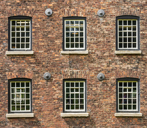 Restored industrial cotton mill with pattern of windows