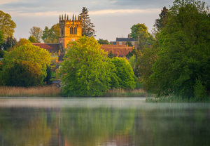 Sunset view across Ellesmere Mere in Shropshire to church