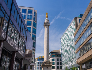 Modern office buildings surround the Monument in London