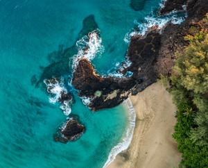 Top down view of rocks and waves on Lumahai beach Kauai