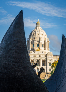 Facade of the State Capitol building in St Paul behind hands