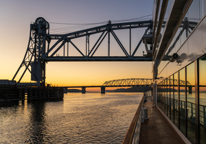 River cruise boat sails under Wabash Railroad bridge
