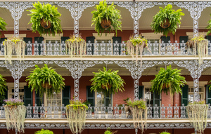 Traditional wrought iron balcony on brick New Orleans house