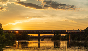 Freight train on the railroad bridge in Austin at sunset