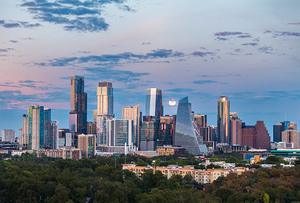 Distant view of Harvest moon in the Austin skyline at sunset