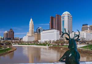 Scioto Lounge statue by waterfront looking at Columbus skyline