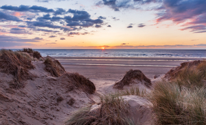 Sunset over Formby Beach through dunes