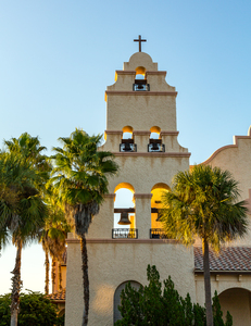 Spanish mission style church tower at sunset