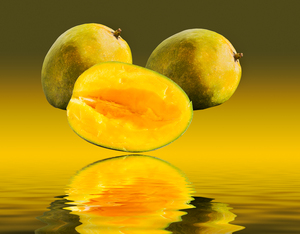 Two mangoes and one cut mango reflecting
