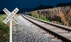 Oncoming train with railroad crossing sign