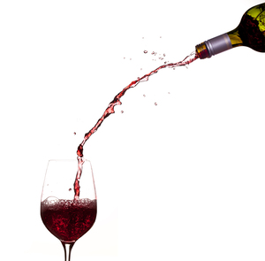 Wine pouring from bottle into glass