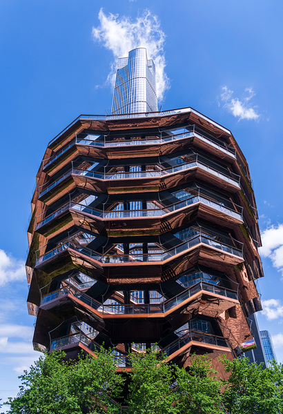 Reflective surface of the Vessel with a skyscraper behind with c by Steve Heap