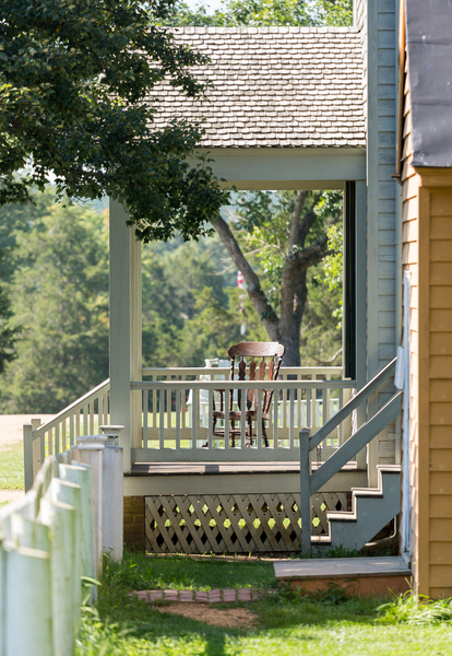Wooden rocking chair on porch of old house by Steve Heap