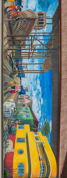 Wall mural of busy port on building in Punta Arenas in Chile by Steve Heap