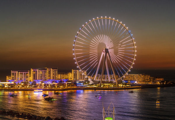 Light show on Ain Dubai observation wheel at sunset by Steve Heap