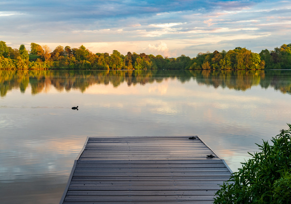 View across the Ellesmere Mere to a clear reflection of distant  by Steve Heap