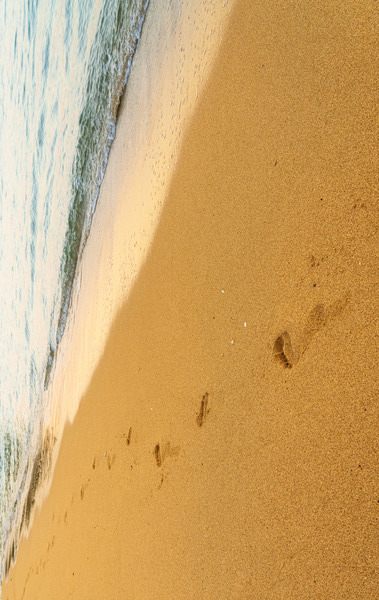Early morning footsteps on Tunnels Beach on Kauai in Hawaii by Steve Heap
