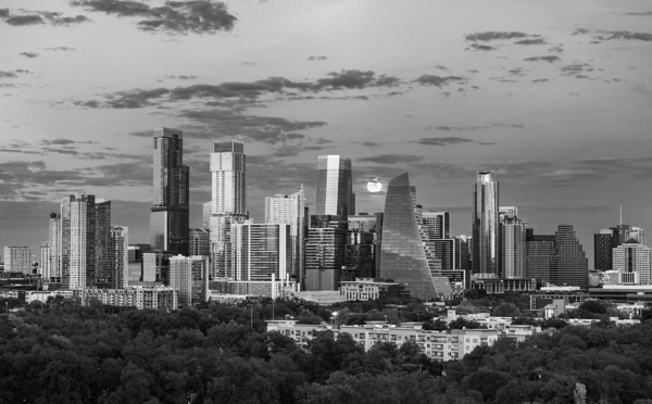 Monochrome view of harvest moon in the Austin skyline by Steve Heap