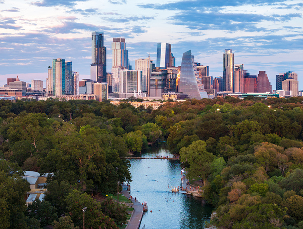 Aerial view of the Austin skyline at sunset over Barton Springs. by Steve Heap