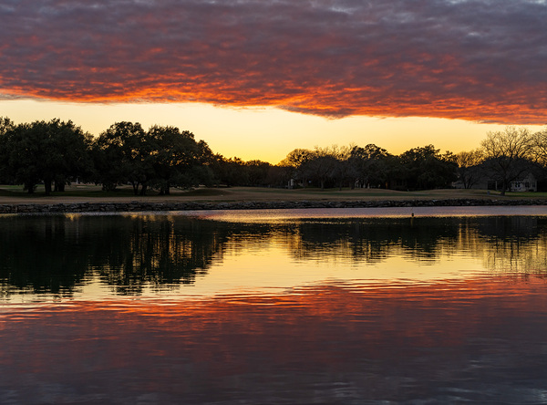 Dramatic sunset over Legacy Hills Park lake and golf course near by Steve Heap