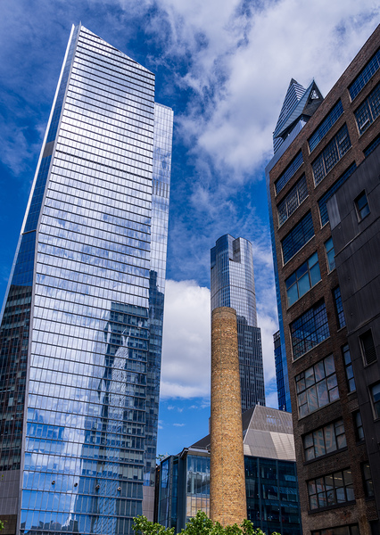 Looking up at modern buildings by brick chimney in Hudson Yards by Steve Heap