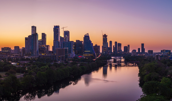 Orange skies behind skyline of Austin Texas as sun starts to ris by Steve Heap