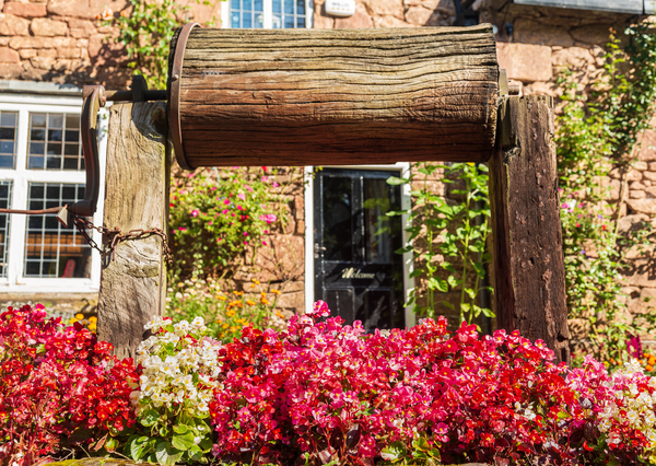 Wooden well winch frames welcome sign by Steve Heap